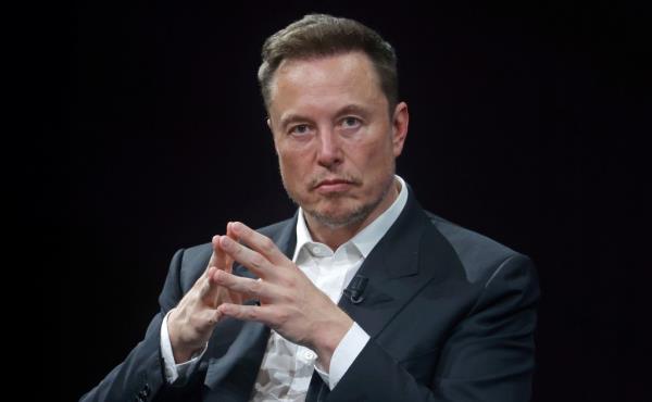 Musk is pictured in a suit.