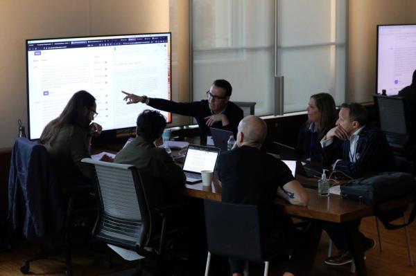 This photo provided by Lauren Feeney shows a group of election officials and AI experts from civil society, academia, industry and journalism testing how different AI models respond to queries voters might ask a<em></em>bout elections