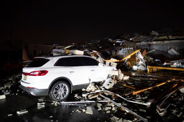 A car is buried under rubble on Main Street after an apparent tornado hit Hendersonville, Tenn