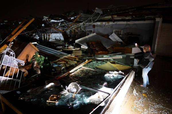 A car is buried under rubble on Main Street after an apparent tornado hit Hendersonville, Tenn