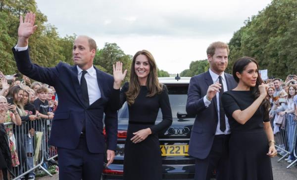 Prince William, Prince Harry, Duchess Meghan, and Catherine, Princess of Wales waving to a crowd outside Windsor Castle