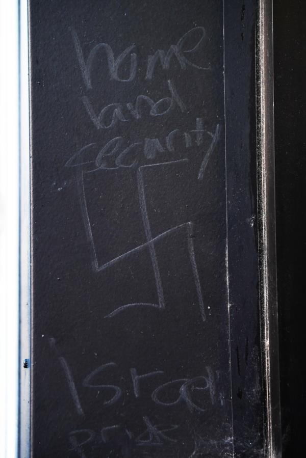 Jeremy Lebewohl owner of the 2nd Ave Deli and the ajoining builing, 400 E 75th St., speaks with the NYPD after finding a 