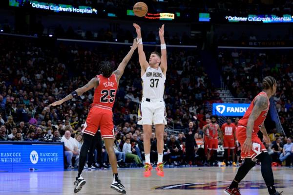 New Orleans Pelicans forward Matt Ryan (37) shoots a three point basket against Chicago Bulls forward Dalen Terry (25) during the second half of an NBA basketball game in New Orleans, Sunday, Feb. 25, 2024.