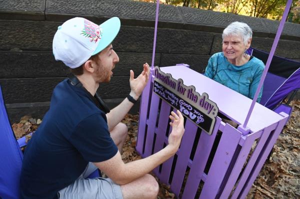 Sol Lowenstein, 29, from the Upper West Side, talks to Grandma Sharon Fitzpatrick, 78, as she works the Grandma Stand at Central Park West and W.63rd St