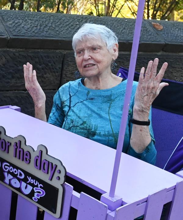 Grandma Sharon Fitzpatrick throws her hands in the air while working at the Grandma Stand on West 63rd Street and Central Park West