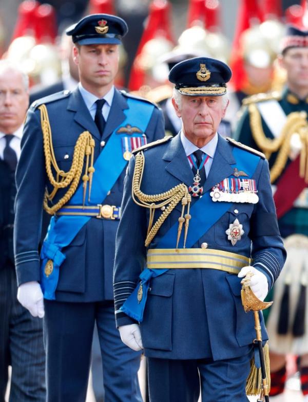 Prince William, Prince Charles, and David Armstrong-Jo<em></em>nes walking behind Queen Elizabeth II's coffin on a gun carriage, transferring from Buckingham Palace to the Palace of Westminster