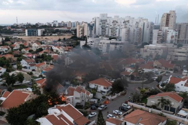 Smoke rises after a rocket fired from the Gaza Strip hit a house in Ashkelon, southern Israel, Saturday, Oct. 7, 2023. The rockets were fired as Hamas announced a new operation against Israel. (AP Photo/Tsafrir Abayov)