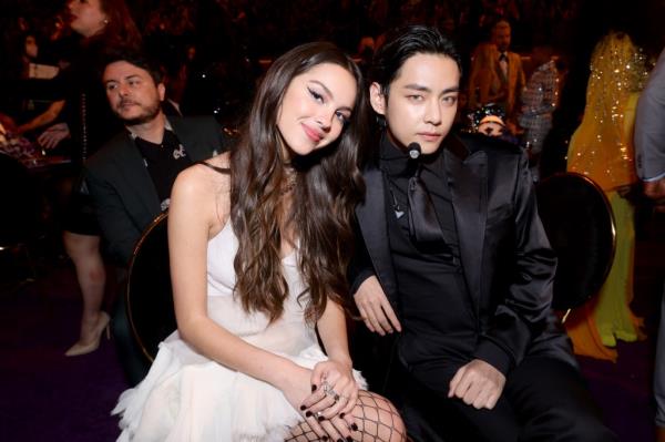 BTS' V and singer Olivia Rodrigo pose for a photo at the 64th Annual Grammy Awards in Las Vegas on April 3, 2022.