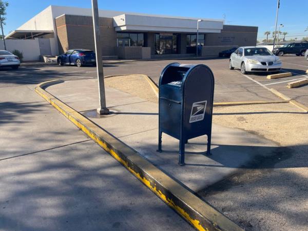 A lone mailbox standing undamaged in a parking lot after a fire at Phoenix Post Office, which resulted in 20 damaged ballots.