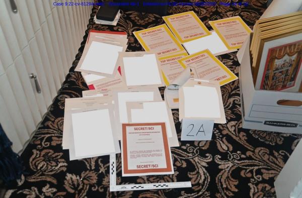 This undated image released by the US Department of Justice, shows a photo attached as evidence to a court filing by the US District Court Southern District of Florida, of docu<em></em>ments allegedly seized at Mar-a-Lago spread over a carpet. 
