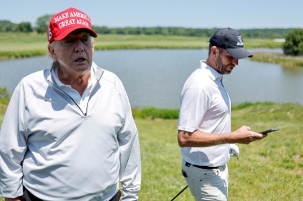 Former U.S. President Do<em></em>nald Trump talks with reporters as he and his son Eric Trump participate in the Pro-Am tournament ahead of the LIV Golf Invitatio<em></em>nal at the Trump Natio<em></em>nal Golf Club in Sterling, Virginia, U.S. May 25, 2023.  