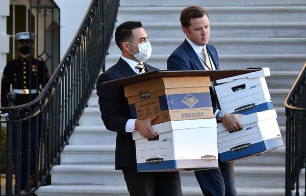 A January 20, 2021 photo shows aides carrying  boxes to Marine One before US president Do<em></em>nald Trump and wife Melania Trump departed from the White House on Trump's final day in office, in Washington, DC. 