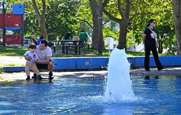 People with their kids at the splash pad