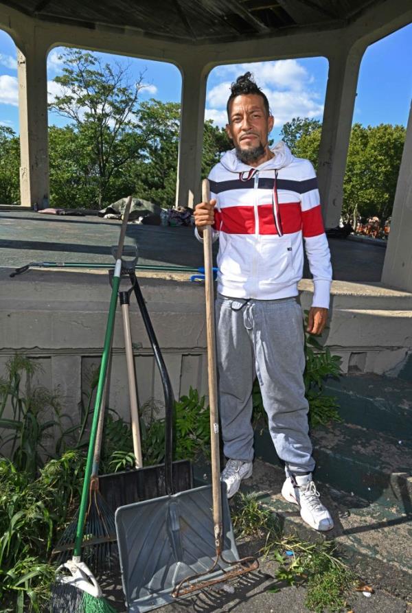 Vazquez with a rake and shovels. 