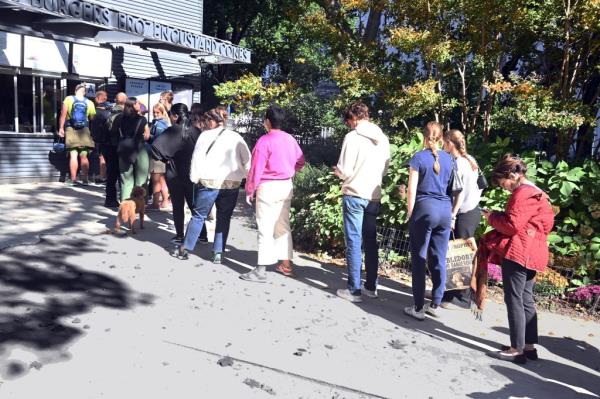 Queue of people waiting at Shake Shack in Madison Square Park for lunch