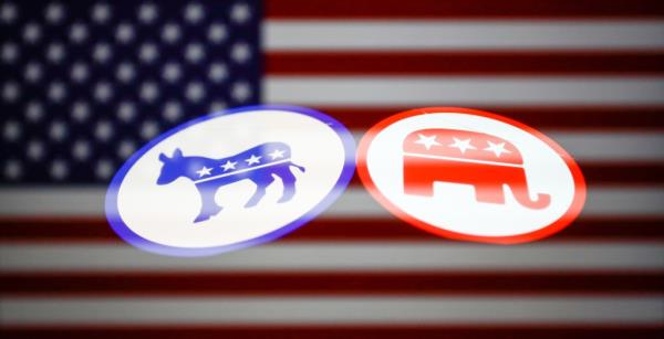 Democratic and Republican parties emblems logos on a phone screen and American flag displayed on a laptop screen.