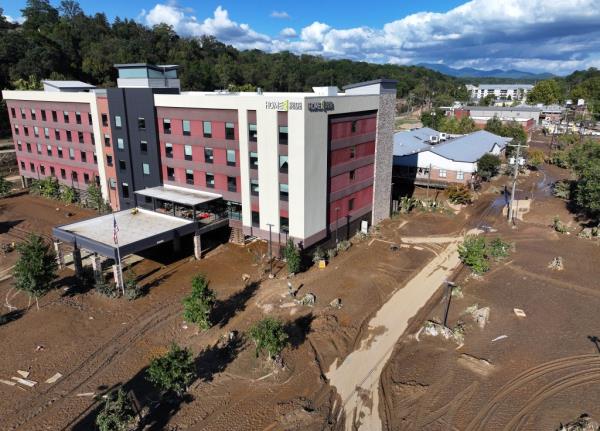 An aerial view shows mud surrounding a hotel left behind by flooding from Hurricane Helene on October 2, 2024 in Asheville, North Carolina.