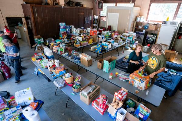People organize food for residents at the Bat Cave Fire Department in the aftermath of Hurricane Helene on October 1, in North Carolina.