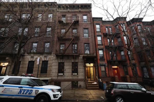 NYPD Crime Scene detectives entering 386 2nd Street in Park Slope, Thursday morning. 