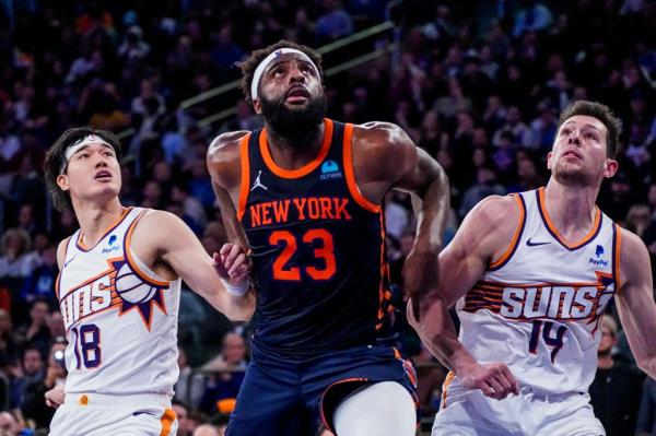Knicks center Mitchell Robinson (23) fights for rebounding position against Phoenix Suns forwards Yuta Watanabe (18) and Drew Eubanks (14) during the second half of an NBA basketball game in New York, Sunday, Nov. 26, 2023. (AP Photo/Peter K. Afriyie)