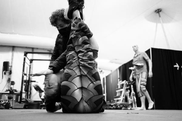 A Cirque performer stretching before a show.