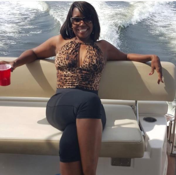 Tanya Smith, smiling as she sits on a boat