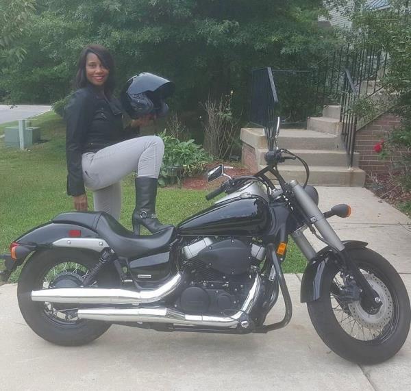 Tanya Smith posing alo<em></em>ngside a motorcycle