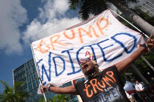 A protester holds a sign in front of the Wilkie D. Ferguson Jr. United States Courthouse before the arraignment of former President Do<em></em>nald Trump in Miami, Florida on June 13, 2023. Trump is appearing in court in Miami for an arraignment regarding 37 federal charges, including violations of the Espio<em></em>nage Act, making false statements, and co<em></em>nspiracy regarding his mishandling of classified material after leaving office.