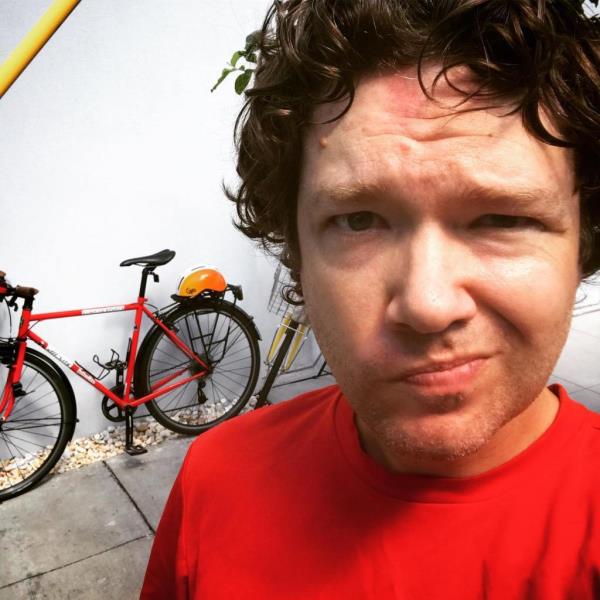 Timothy Burke with a bike in the background.