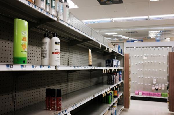 Shelves sit nearly empty at a pharmacy and co<em></em>nvenience store on October 26, 2021 in New York City