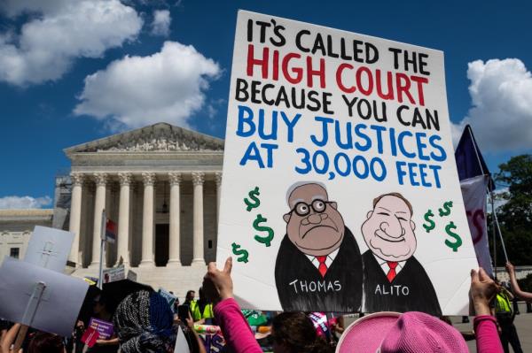 An abortion rights activist lampoons U.S. Supreme Court justices Clarence Thomas and Samuel Alito during a march to Washington, D.C.'s Capitol Hill on June 24, 2023. 