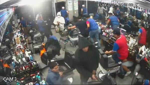 Surveillance camera footage from el cache barbershop of gunman walking to back of shop