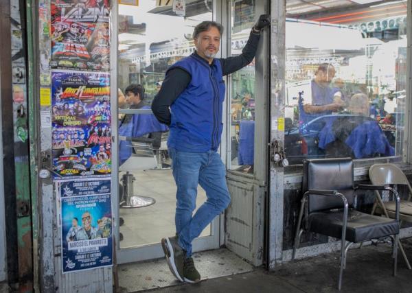 Rafael Abreu outside of the barbershop wher<em></em>e he works 