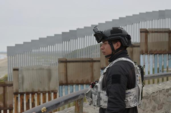 Borders officials on both the US and Mexican sids of the border have been guilty of corruption.  Here, a guard stands watch at Tijuana, Mexico.