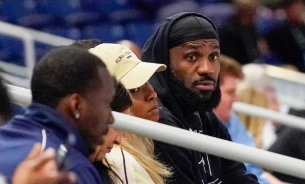 LeBron James watches his son at the Combine.