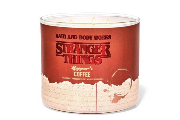 A candle with three wicks on a table