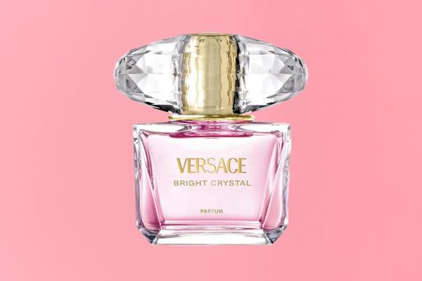 A pink bottle of Versace perfume displayed on a gift guide cover, photo by Marshall Troy and styled by Miako Katoh