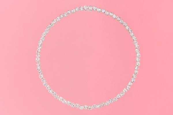 Diamond heart necklace on a pink background