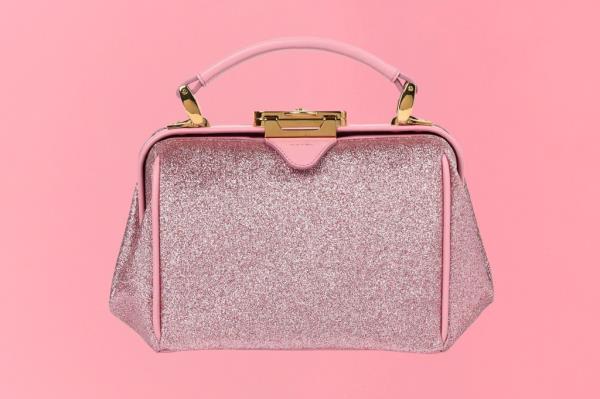Pink handbag with a handle featured on a gift guide cover
