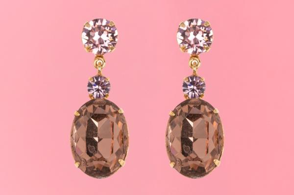 A pair of dangle earrings with a large oval stone and a small pink gem