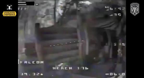 First-person footage shows a Ukrainian kamikaze drone flying through a dense forest in search of a Russian hideout.