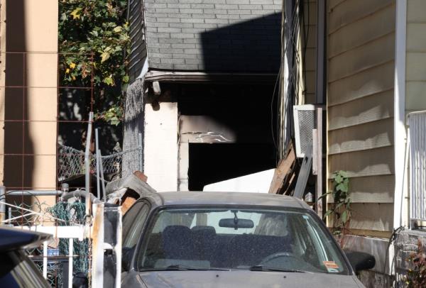 Photo shows a car in the driveway in front of the garage.