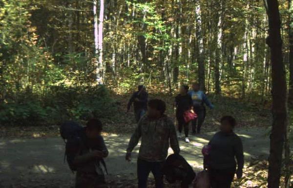 A group of foreign natio<em></em>nals illegally entering the U.S. from Canada through the Swanton Sector, in a wooded area