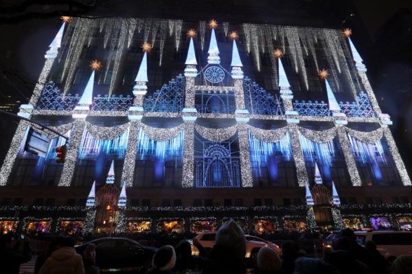 People look at the Christmas light show at the Saks Fifth Avenue store on 5th Avenue