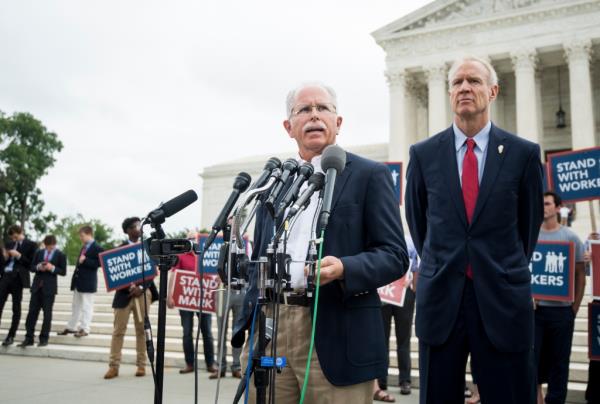 Illinois state employee Mark Janus, left, and Gov. Bruce Rauner, R-Ill., speak to the press outside of the U.S. Supreme Court after the decision in the Janus v. AFSCME case was handed down in Janus' favor on Wednesday, June 27, 2018. 