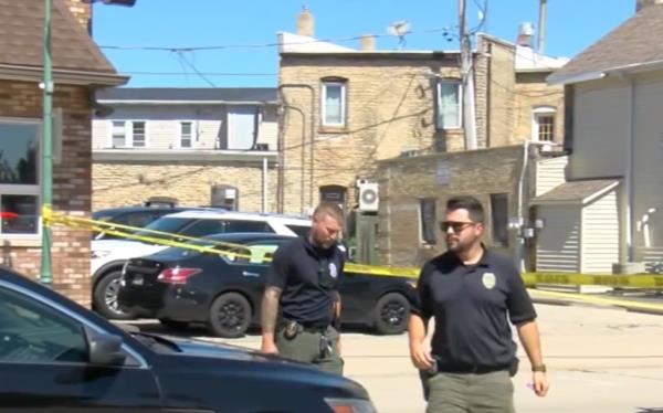 Police officers investigating the scene of the fatal shooting.