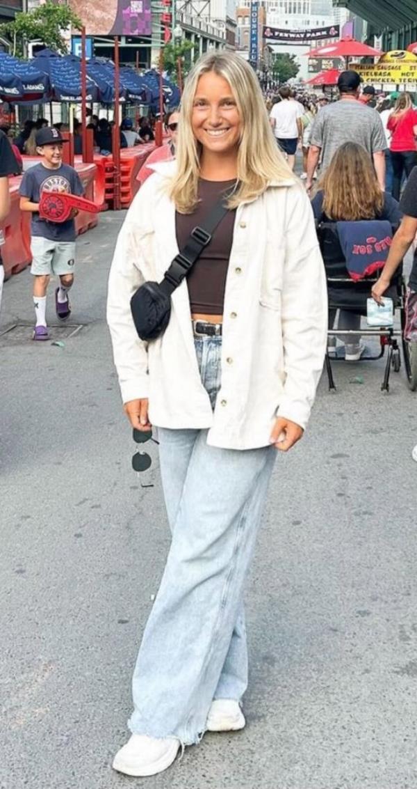 Lexie Firment wearing HOKAs with jeans at Fenway Park
