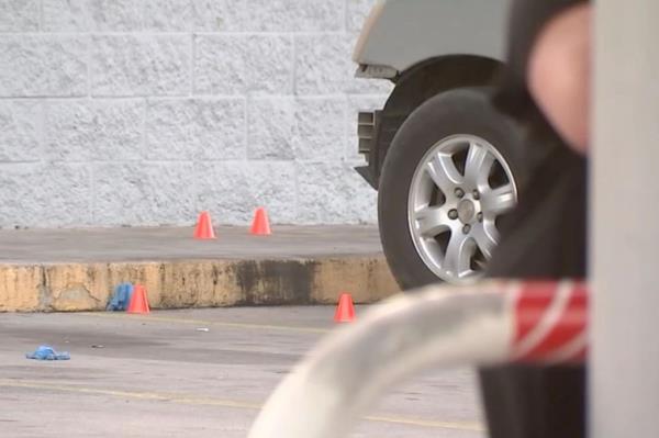Police tape and police car outside of Houston gas station