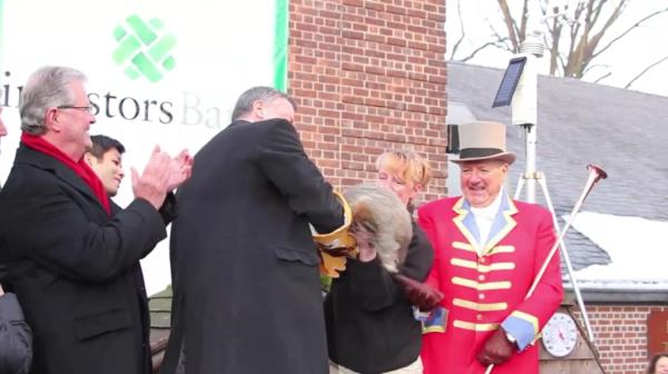 Mayor Bill de Blasio drops a groundhog as a zookeeper reacts with shock.
