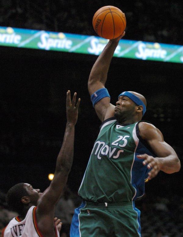 Dallas Mavericks center Erick Dampier taking a shot over Atlanta Hawks guard Royal Ivey during a basketball game at Philips Arena in Atlanta, 2004